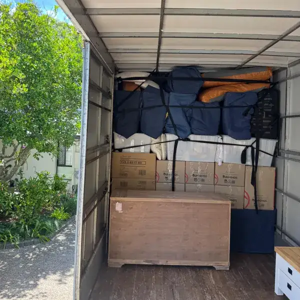 Safepack truck loaded with boxes and furniture wrapped in moving blankets